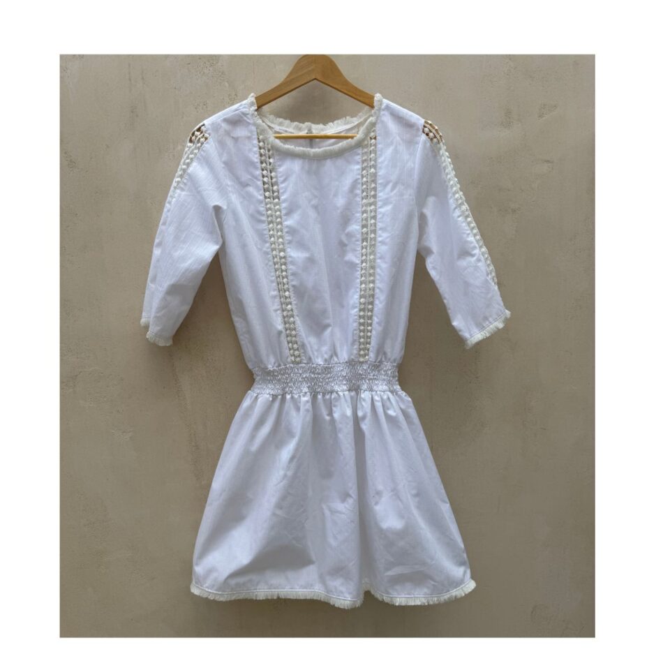 vestido encaje blanco mini con cintura smock, encaje vertical y flecos delicados de la marca After/Before