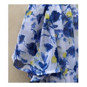 Vestido maxi floral en tonos oceánicos: capas de volantes vaporosos, estampado acuarela de flores índigo y amarillo sol sobre blanco puro. Cintura smocked y mangas flutter para un look cottagecore